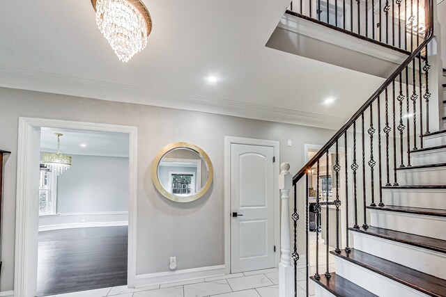 5801 N Drake Ave, Chicago, IL 60659 - entrance foyer featuring crown molding, baseboards, stairway, and an inviting chandelier