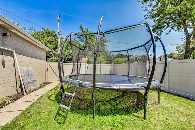 5801 N Drake Ave, Chicago, IL 60659 - exterior space featuring a yard, a fenced backyard, and a trampoline