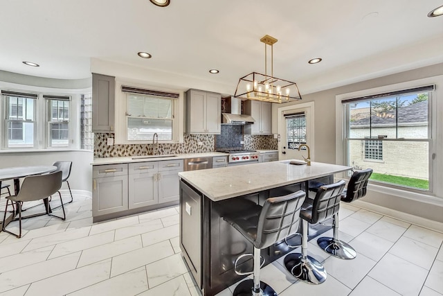 5801 N Drake Ave, Chicago, IL 60659 - kitchen with gray cabinets, a sink, baseboards, and wall chimney exhaust hood