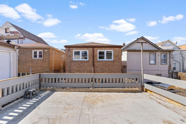 view of front of property with fence and brick siding