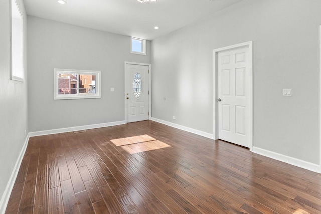 foyer entrance with dark wood finished floors, baseboards, and recessed lighting