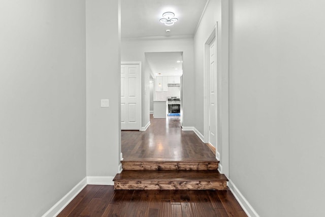 corridor with baseboards and wood-type flooring