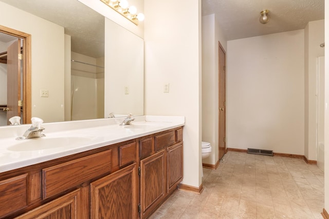 full bathroom with visible vents, toilet, baseboards, and a sink