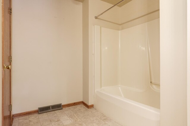 bathroom with  shower combination, baseboards, and visible vents