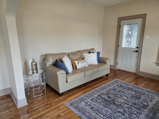 601 Powell St, Streator, IL 61364 - living area featuring arched walkways, wood finished floors, and baseboards