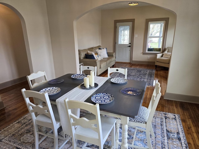 601 Powell St, Streator, IL 61364 - dining space with baseboards, arched walkways, and wood finished floors