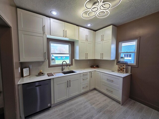601 Powell St, Streator, IL 61364 - kitchen featuring a sink, light countertops, a wealth of natural light, and dishwasher