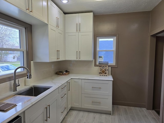 601 Powell St, Streator, IL 61364 - kitchen featuring plenty of natural light, light wood-type flooring, and a sink