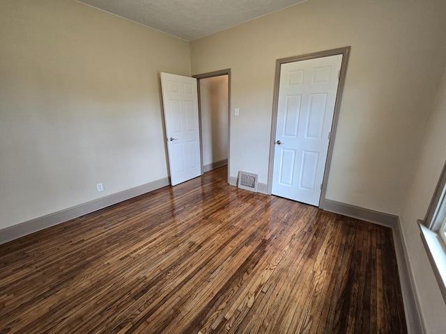 601 Powell St, Streator, IL 61364 - unfurnished bedroom with visible vents, baseboards, and wood finished floors