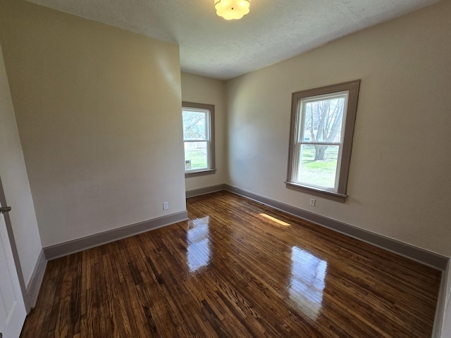 601 Powell St, Streator, IL 61364 - unfurnished room featuring dark wood-type flooring and baseboards