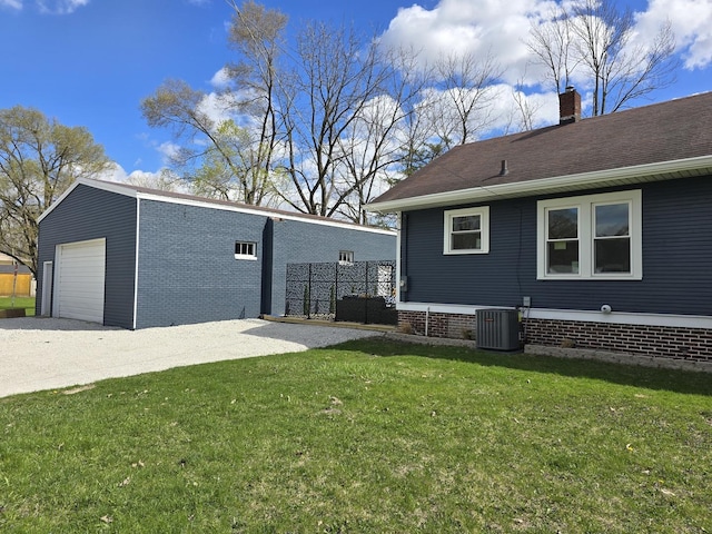 601 Powell St, Streator, IL 61364 - view of side of property featuring central AC, a chimney, a yard, and an outbuilding