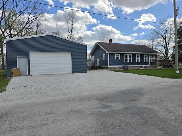 601 Powell St, Streator, IL 61364 - ranch-style house featuring central AC, a detached garage, a chimney, an outbuilding, and a front lawn