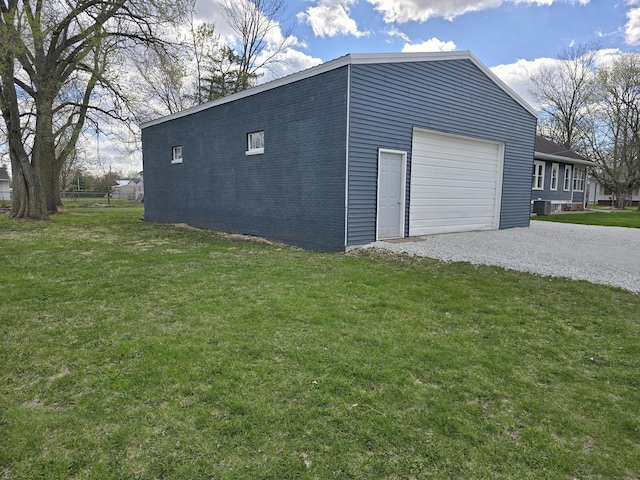 601 Powell St, Streator, IL 61364 - view of side of home featuring gravel driveway, central AC unit, and a lawn