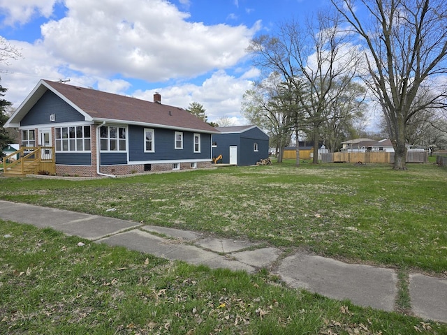 601 Powell St, Streator, IL 61364 - exterior space featuring a sunroom, a chimney, fence, and a yard