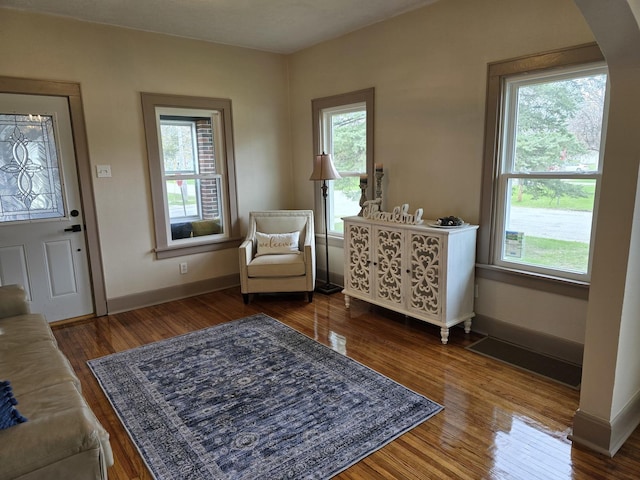 601 Powell St, Streator, IL 61364 - sitting room with a wealth of natural light, arched walkways, baseboards, and dark wood finished floors
