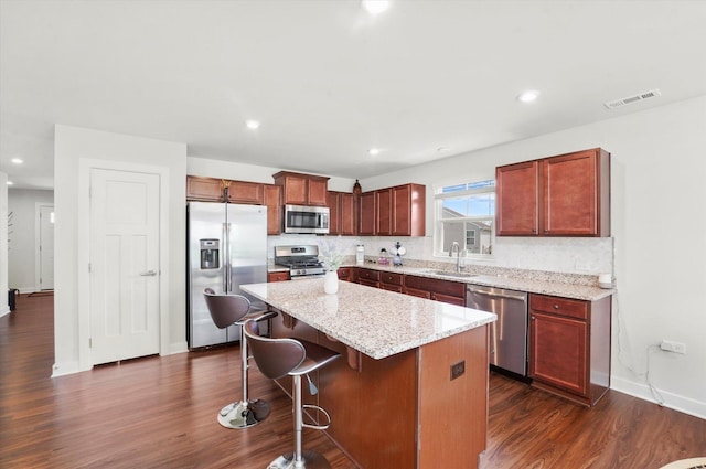 2834 Ketchum Ct, Yorkville, IL 60560 - kitchen featuring a center island, appliances with stainless steel finishes, decorative backsplash, and dark wood-style floors