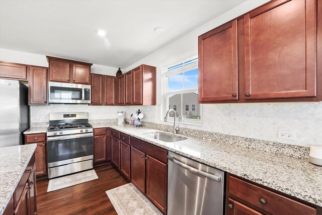 2834 Ketchum Ct, Yorkville, IL 60560 - kitchen with tasteful backsplash, dark wood-style flooring, light stone counters, appliances with stainless steel finishes, and a sink