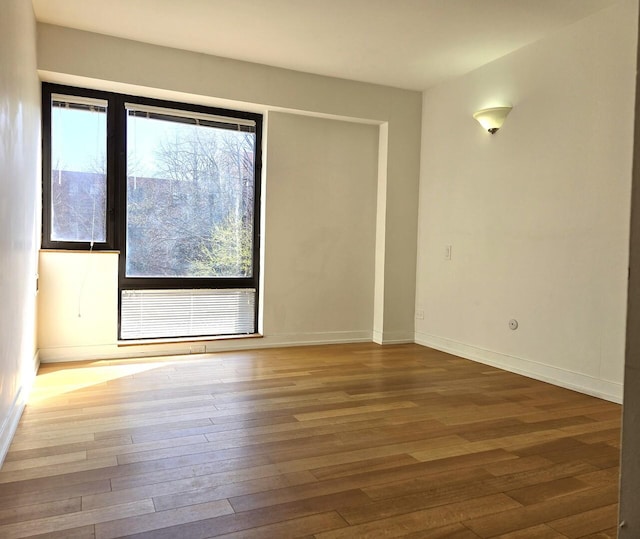 1115 S Plymouth Ct Unit 303, Chicago, IL 60605 - unfurnished room featuring baseboards and hardwood / wood-style floors