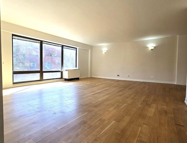 1115 S Plymouth Ct Unit 303, Chicago, IL 60605 - spare room featuring baseboards and wood finished floors