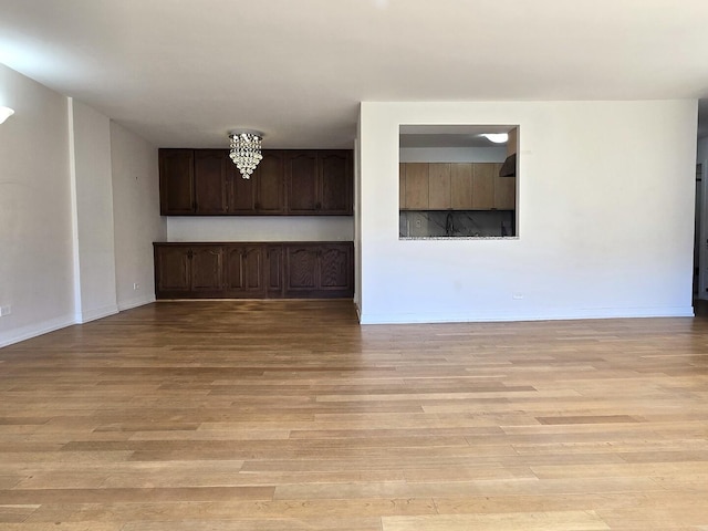1115 S Plymouth Ct Unit 303, Chicago, IL 60605 - unfurnished living room with light wood finished floors and baseboards