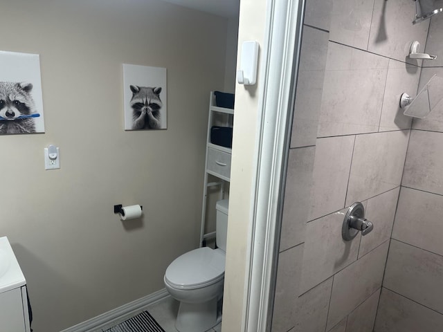 full bathroom with baseboards, a tile shower, and toilet