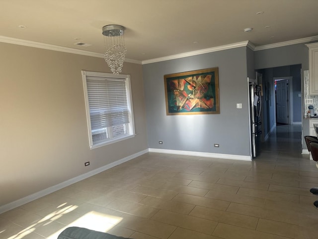 tiled empty room with crown molding, baseboards, and a chandelier