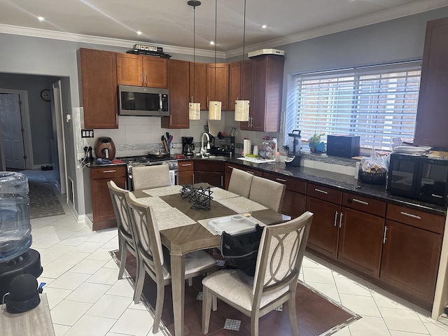 kitchen featuring appliances with stainless steel finishes, light tile patterned flooring, a sink, and recessed lighting