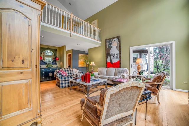 living area featuring high vaulted ceiling and wood finished floors