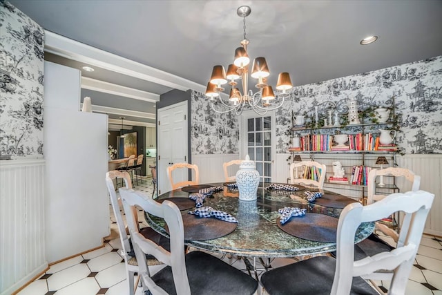 dining space with a wainscoted wall and wallpapered walls