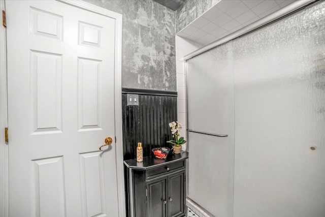 bathroom featuring a shower with door