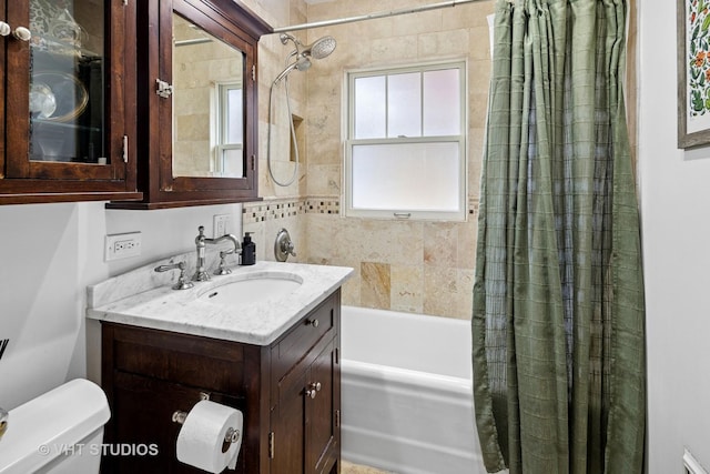 full bathroom featuring toilet, vanity, and shower / bathtub combination with curtain