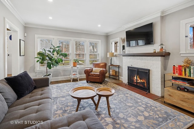 living area featuring recessed lighting, wood finished floors, crown molding, baseboards, and a brick fireplace