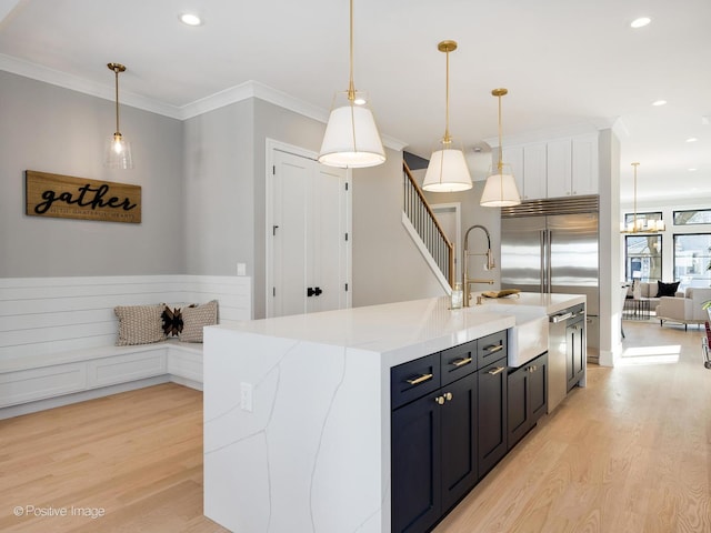 kitchen with ornamental molding, light wood-style flooring, and recessed lighting