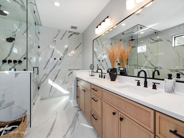 full bathroom featuring toilet, a marble finish shower, a sink, and visible vents