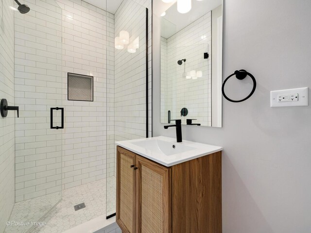 bathroom featuring a shower stall and vanity