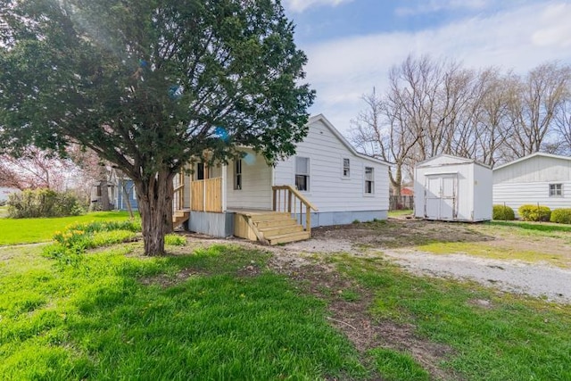 back of house featuring a shed and an outdoor structure