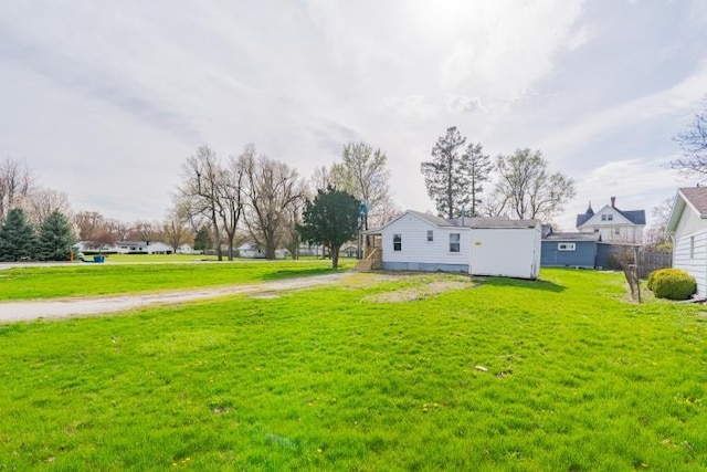 view of yard with dirt driveway