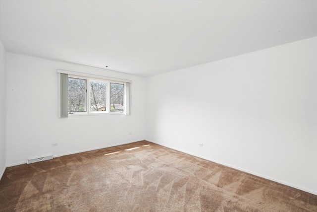 empty room featuring visible vents, baseboards, and carpet floors