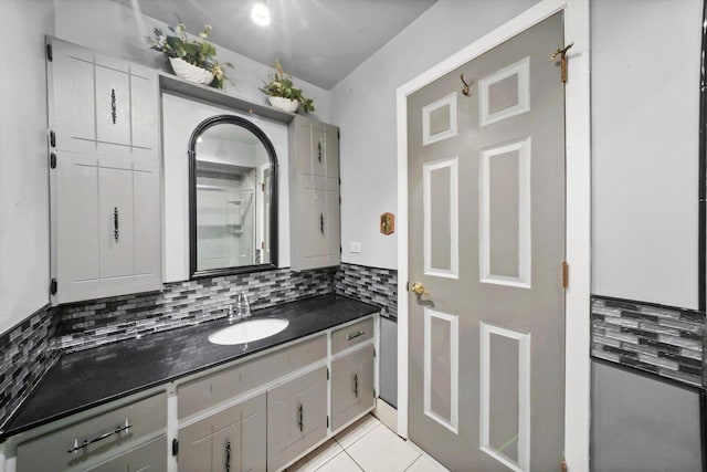 bathroom featuring tile patterned floors, decorative backsplash, and vanity