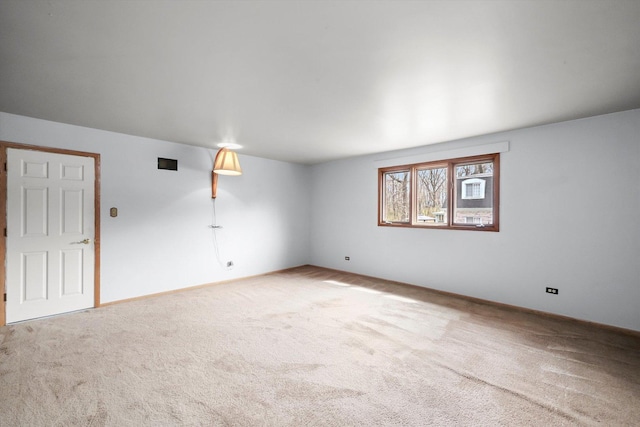 carpeted spare room with baseboards