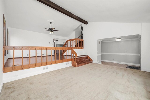 additional living space with lofted ceiling with beams, carpet, a ceiling fan, visible vents, and stairway