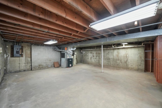 unfinished basement featuring electric panel and heating unit