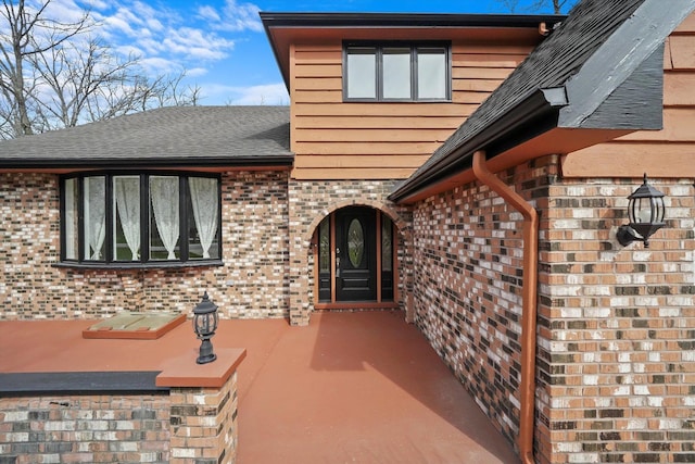 property entrance with brick siding