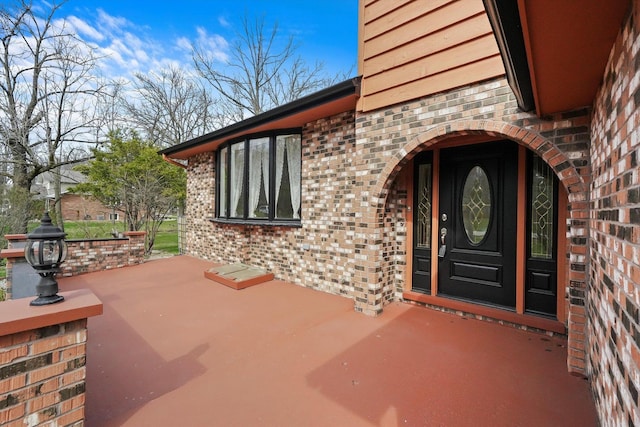entrance to property with brick siding