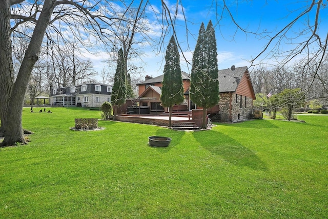 view of yard featuring a wooden deck and an outdoor fire pit