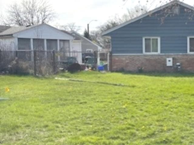275 Blackhawk Dr, Park Forest, IL 60466 - view of green lawn with a sunroom