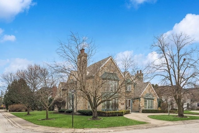 view of front facade featuring a front lawn and a chimney