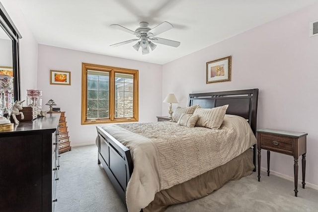 bedroom featuring light colored carpet, baseboards, a ceiling fan, and visible vents