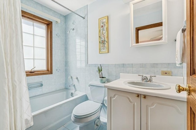 full bath featuring shower / tub combo, toilet, tile walls, vanity, and backsplash