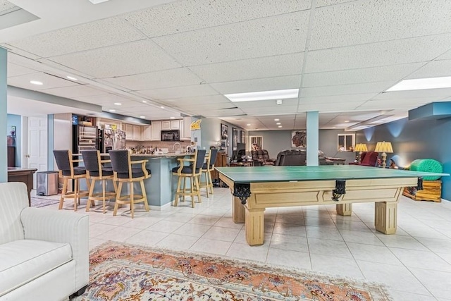 playroom with light tile patterned floors, pool table, bar area, a drop ceiling, and recessed lighting